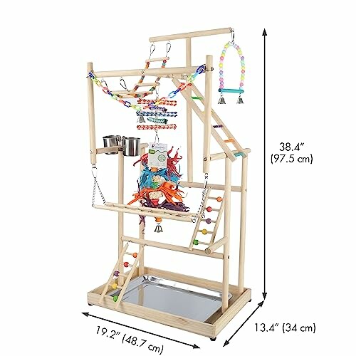 Wooden parrot play stand with toys and feeding cups.
